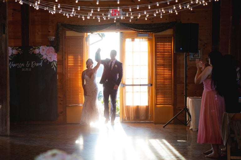 A bride and groom standing in front of a barn door at Linganore Winecellars in Mt. Airy, Maryland.