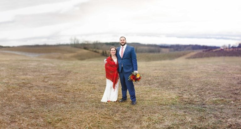 A bride and groom standing in a field at Linganore Winecellars in Mt. Airy, Maryland.