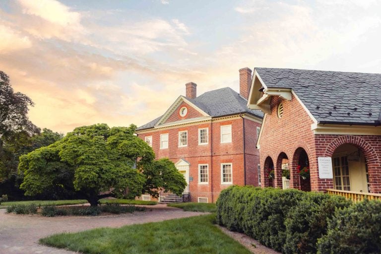 A brick house in Laurel with a tree in front of it, near Montpelier Mansion.