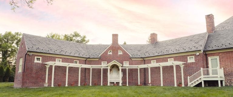 A brick house with a gazebo in the middle of a grassy field near Montpelier Mansion, Laurel, Maryland.