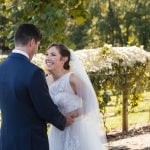 A wedding couple gracefully posing amidst the picturesque vineyard backdrop of Fleetwood Farm Winery.