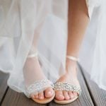 Detail of a bride's wedding shoes on a wooden deck at Fleetwood Farm Winery.