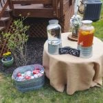 A wedding table with two jars of drinks as decorative details.