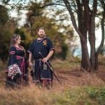 A medievalthemed wedding portrait in a field.