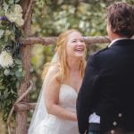 A laughing bride and groom at their wedding ceremony.