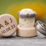 A wedding ring intricately placed on a wooden wine cork.