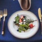 A wedding table adorned with salad and forks.