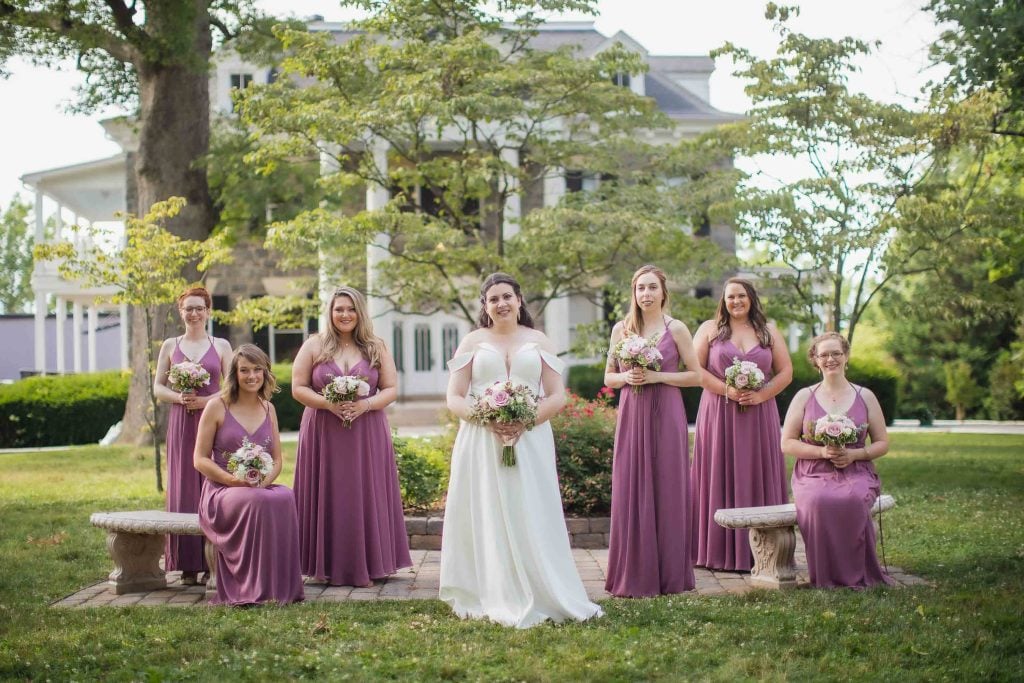 A bride and her bridesmaids pose for a wedding portrait.