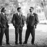 Wedding portrait of three groomsmen in suits.