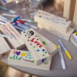 A detailed table display with markers and wooden blocks, perfect for a wedding.