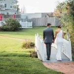 A wedding couple walking down a ceremony walkway.