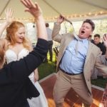 A bride and groom dancing at the reception of their wedding.