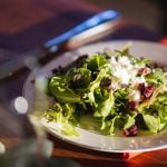 A wedding plate with a salad on it.