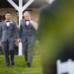 Two grooms participating in a wedding ceremony.