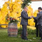 Two men exchanging rings at a wedding ceremony.