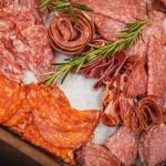 A tray full of different kinds of meats for a wedding event.