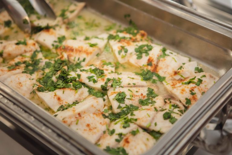 A tray of fish with parsley on it, ideal for wedding receptions with attention to details.