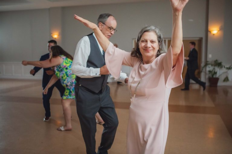 An elegant wedding reception with an older couple dancing gracefully.