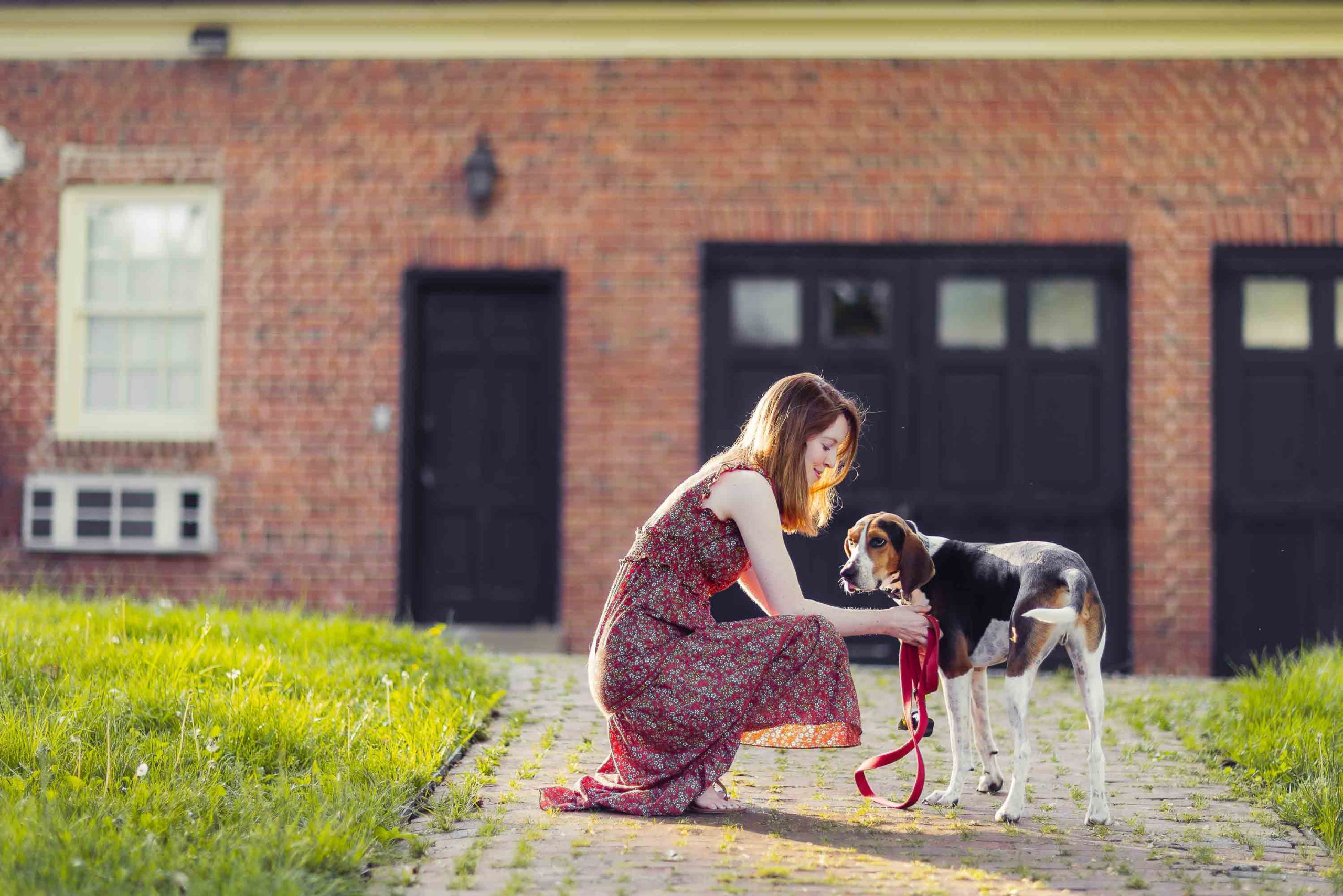 A woman is petting her dog at Montpelier Mansion.