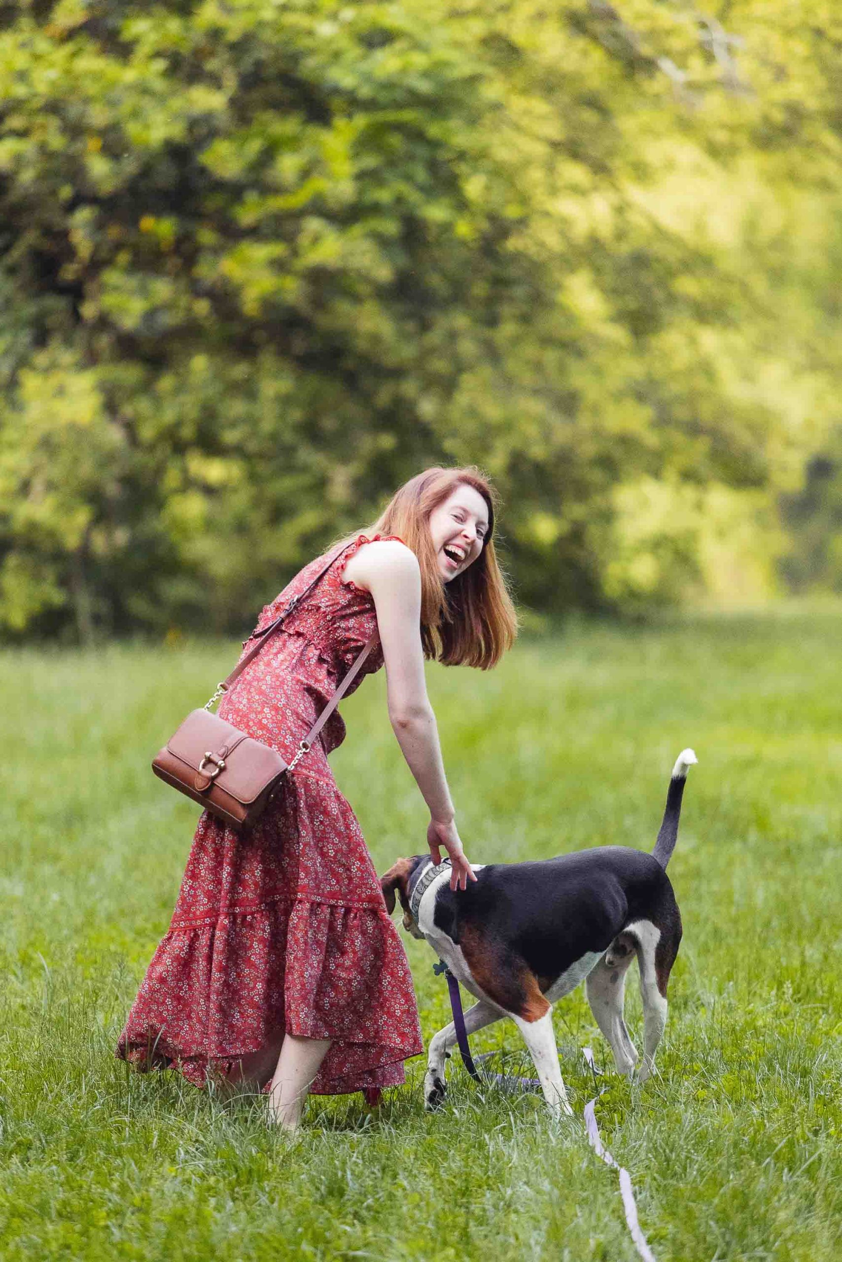 A woman is playing with her dog at Montpelier Mansion.