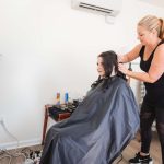 A woman preparing for her wedding by getting her hair done in a salon.