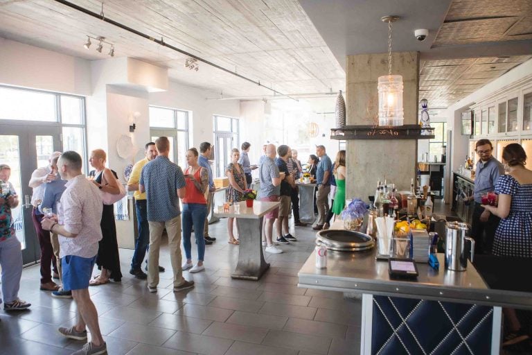 A crowd of people celebrating at a bar.