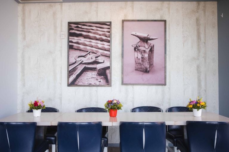 A table with blue chairs.