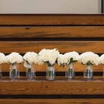 White flowers on wooden stairs.