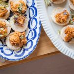 Two plates of appetizers on a wooden table at a Birthday Party.