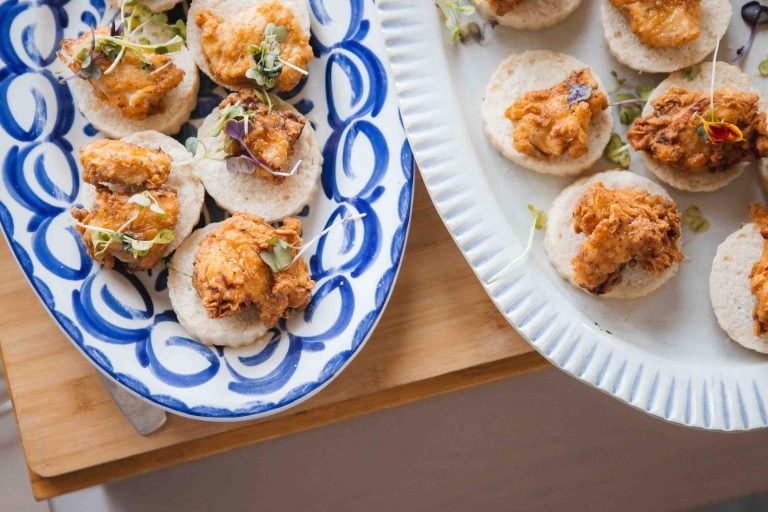 Two plates of appetizers on a wooden table at a Birthday Party.