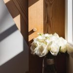 White roses on a window sill.