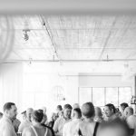 A black and white photo of a group of people celebrating at a birthday party.