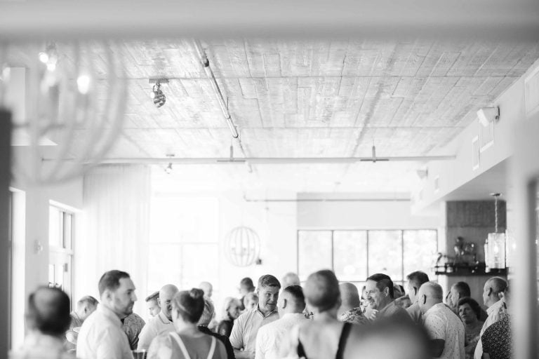 A black and white photo of a group of people celebrating at a birthday party.