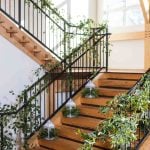 A wedding staircase adorned with plants and intricate details.