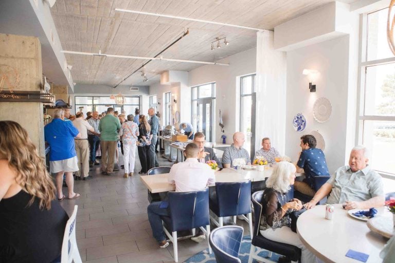 A group of people sitting at tables in the Hummingbird Bar & Kitchen restaurant in Alexandria, Virginia