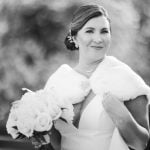 A black and white wedding portrait featuring a bride holding a bouquet.