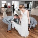 A candid bride preparing at her wedding reception.