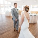 A candid bride and groom sharing a tender moment during wedding preparation.