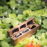 A detailed wooden box containing wedding rings.