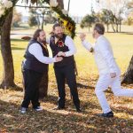 A group of groomsmen jumping in the air during a wedding ceremony. (Keywords: Wedding, Ceremony)