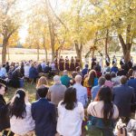 A wedding ceremony with a large group of people.