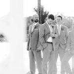 A group of groomsmen posing for a wedding portrait.