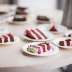 A table with a variety of cake at a birthday party.