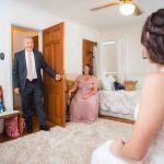 A bride is preparing with her bridesmaids for the wedding.