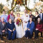 A group of people posing for a wedding portrait.