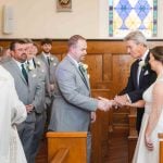 A couple performs their wedding ceremony in a church.