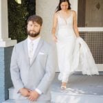 A candid shot of the bride and groom during their wedding preparations.