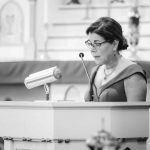 A woman giving a speech at a wedding ceremony.