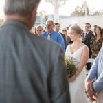 A bride walks down the aisle at a wedding ceremony.