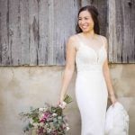 A bride in a white wedding dress posing for a portrait.